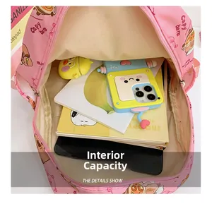 Internal view of the pink cartoon backpack showing spacious capacity for books and tablets