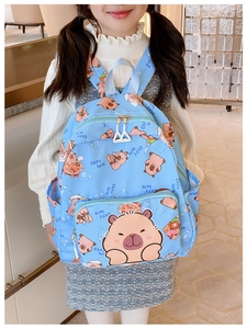 Detailed view of kids' sky blue backpack featuring cute cartoon capybara prints and dual zippers