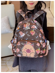 Detail of cute Capybara cartoon print on brown nursery backpack with white zip pulls