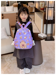 Close-up of purple Capybara backpack for kids with cute cartoon design and side pockets