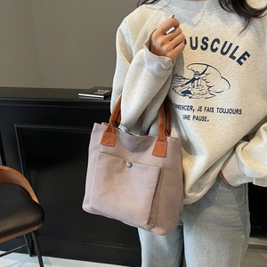 Minimalist lavender canvas tote bag with orange handles and silver snap pocket