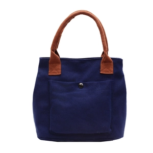 Grand sac fourre-tout minimaliste en toile bleu marine avec poignées marron et poche avant