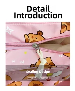 Detail of pink cartoon canvas bag featuring a metal zipper and white cotton drawstring closure