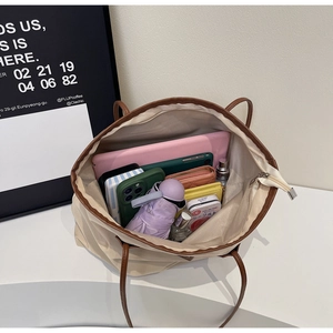 Top view of large beige tote bag interior showing capacity for tablets and essentials