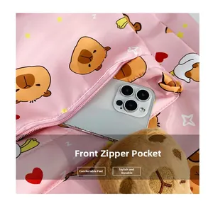 Detailed view of pink cartoon tote bag with front zipper pocket and plush animal charm
