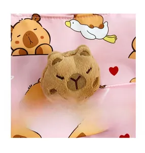 Close-up of cute plush capybara accessory with detailed embroidery and soft texture