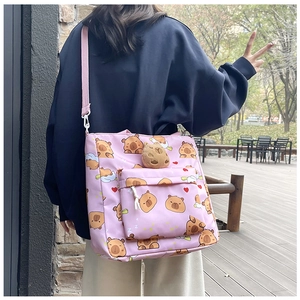 Pink canvas crossbody bag featuring Capybara prints and a cute plush charm accessory