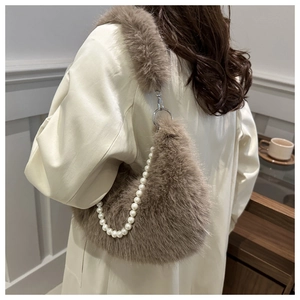 Détail du sac croissant en fausse fourrure marron avec chaîne en perles et bandoulière