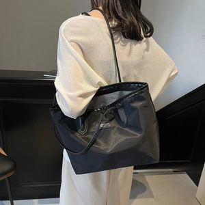 Classic large black nylon tote bag with leather straps for commuting and casual use
