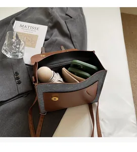 Interior view of patchwork college style backpack showing storage for phone and umbrella