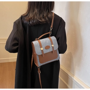Retro denim crossbody bag with brown leather trim shown on model back for size reference