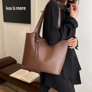 Brown large capacity PU leather tote bag with stylish woven tassel and minimalist design