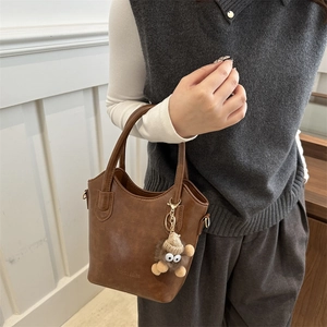 Vintage brown leather bucket bag for women with plush doll charm and double handles