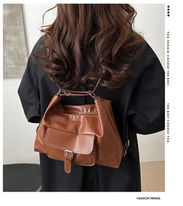 Brown vintage multi-functional PU leather backpack showing adjustable strap and buckle