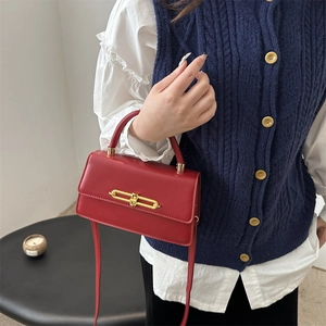 Elegant red leather handbag with gold metal lock and shoulder strap for women
