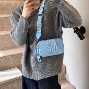Chic light blue crossbody square bag with SM logo embossing and wide geometric strap