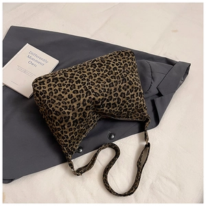 Close-up of leopard print bucket bag texture with zipper and durable canvas shoulder strap
