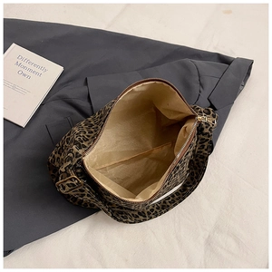 Detail of leopard print bucket bag interior showing large capacity and zipper closure