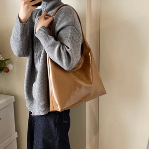 Chic glossy dark brown large tote bag worn as a shoulder bag in a mirror selfie view