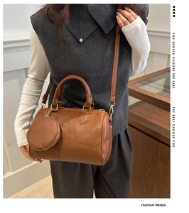 Close-up of brown litchi pattern leather Boston bag with detachable round coin purse