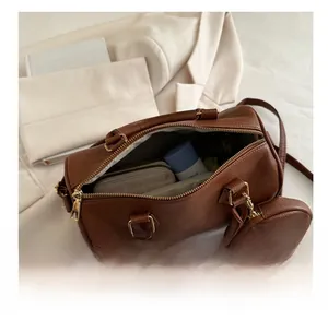 Top view of brown lychee leather Boston bag showing interior capacity and mini coin purse