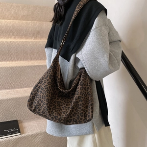 Large leopard print bucket tote bag in canvas featuring wide straps for daily commuting