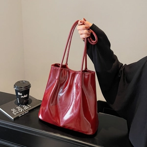 Classic burgundy high-gloss tote bag featuring soft leather texture and long handles