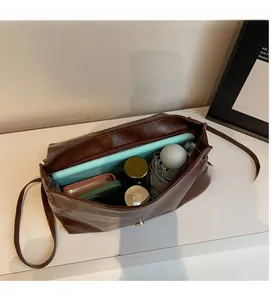 Internal view of large vintage leather backpack showing storage for tablets and gadgets