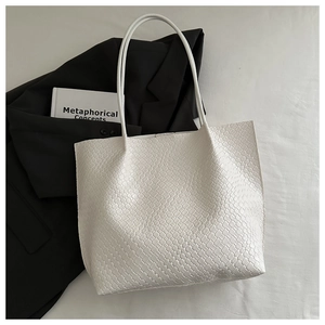 Detailed view of large white woven tote bag for commuting with crossbody texture