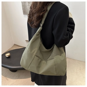 Detailed back view of an olive green large-capacity nylon tote bag with wide strap