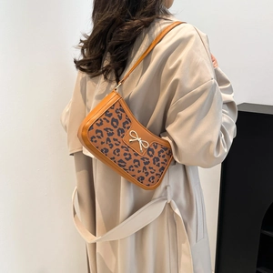 Chic leopard print shoulder bag with brown leather trim and silver bow buckle for women
