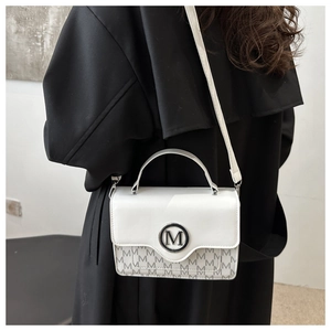 Detail of white leather mini square bag with silver M logo and monogram print