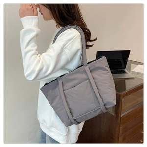 Grey quilted tote bag for women showing spacious interior and soft shoulder straps
