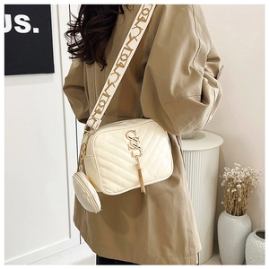 Ivory quilted crossbody bag with gold tassel, jacquard strap, and mini pouch detail
