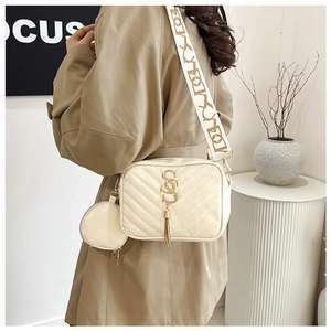 Detail of cream quilted crossbody bag with golden S-logo and jacquard wide strap