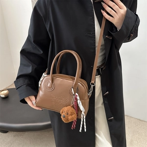 Brown leather crossbody bag with letter embossing and cute teddy bear pendant