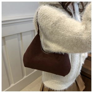 Detail of hobo bag in dark brown frosted suede with silver zipper and slim strap