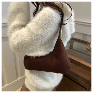 Brown matte suede hobo bag with asymmetric geometric design and silver studs detail