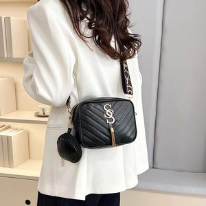 Quilted black crossbody camera bag with wide woven strap and mini round coin pouch