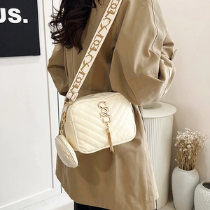Cream white crossbody camera bag with V-quilt pattern, wide strap and small round pouch