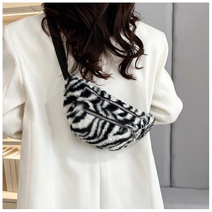 Detail of zebra pattern faux fur waist bag with double zippers and nylon straps