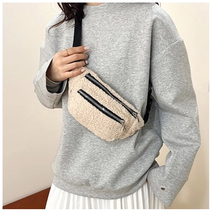 Detail of plush crossbody waist bag with double zippers and black nylon shoulder strap
