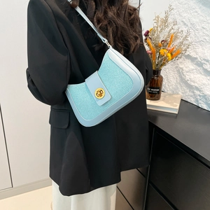 Chic light blue tweed shoulder bag with gold twist lock on a minimalist black blazer outfit
