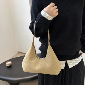 Minimalist light brown matte suede shoulder bag with streamlined design and slim handle