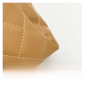Close-up of khaki diamond quilted faux leather tote bag with precise stitching detail