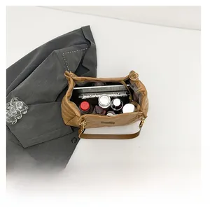 Interior view of large quilted tote bag showing storage space for tablet and bottles