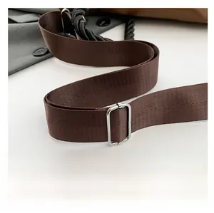 Close-up of adjustable dark brown woven shoulder strap with polished silver metal buckle