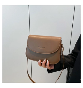 Detail of brown leather bag with golden hardware and Fashion & Bags text logo