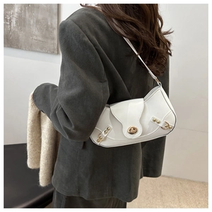 Modern white leather underarm bag with gold hardware and turn-lock on a model