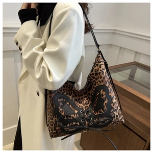 Detail of leopard print hobo bag with butterfly leather patch and lacing on the side